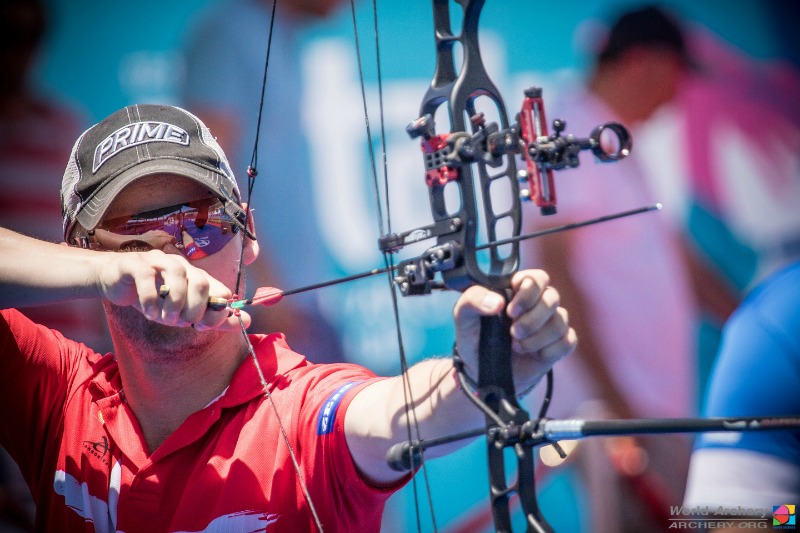 Keeping your grip hand steadily extended at nose height, you then use your release hand to start pulling the bowstring toward your face. You should begin inhaling as the string comes back. Photo Credit: World Archery